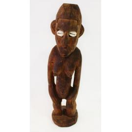 Wooden carved female ancestral figure with shell eyes
