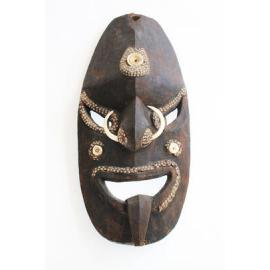 Large mask with inlaid shells and two tusks